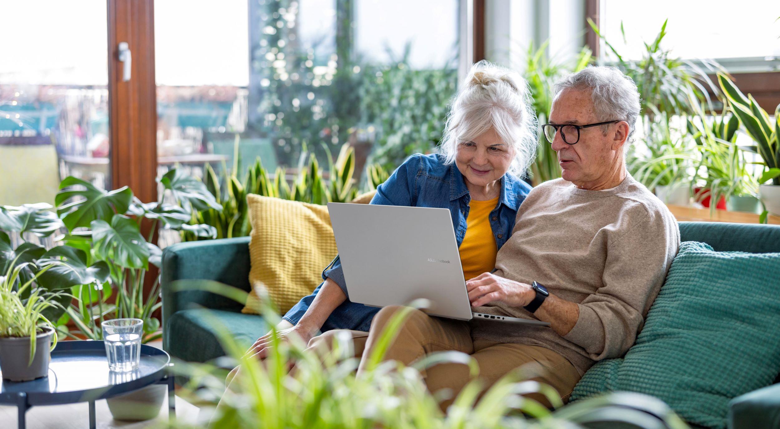 An elderly couple using an ASUS laptop