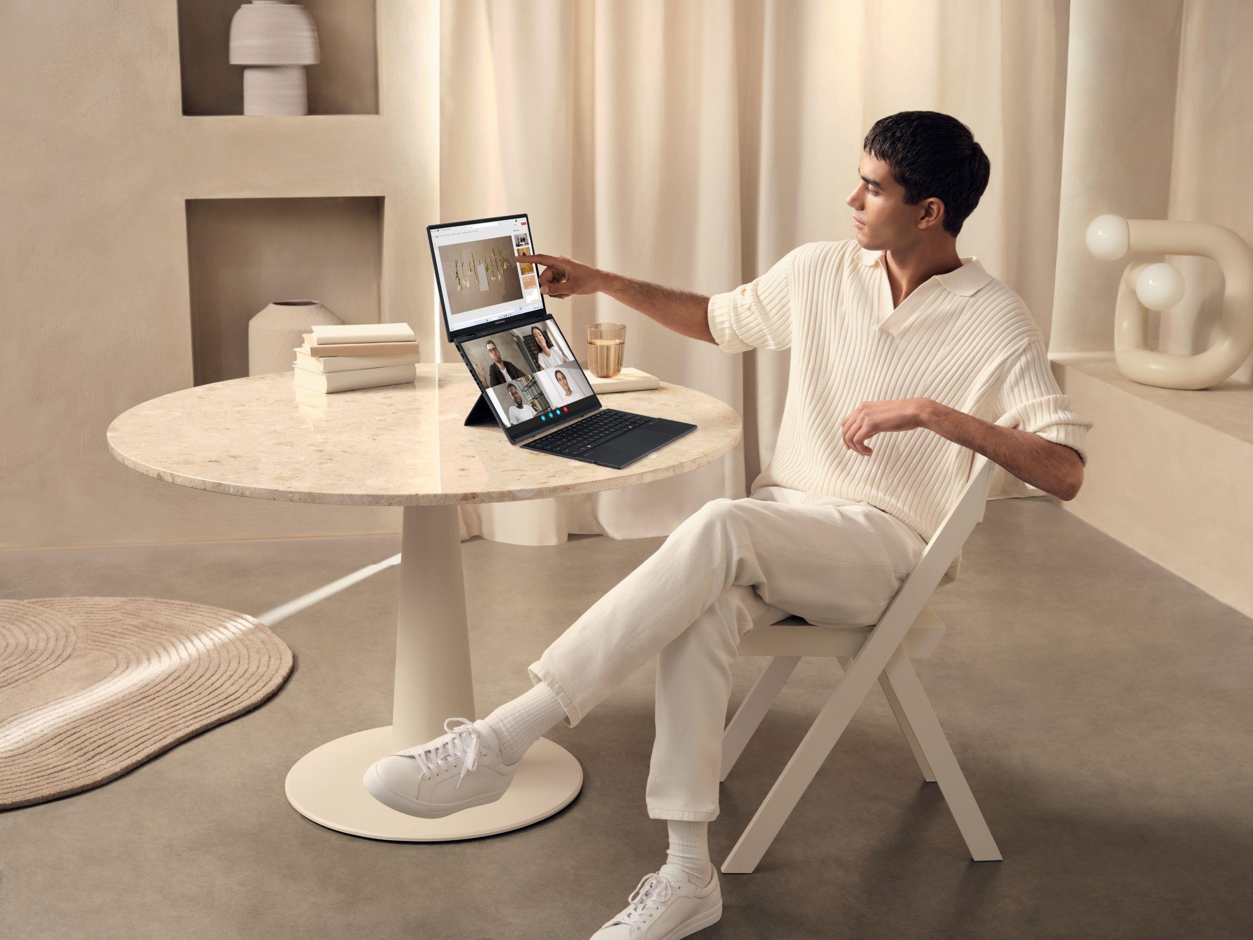 A man at a table using an ASUS Zenbook