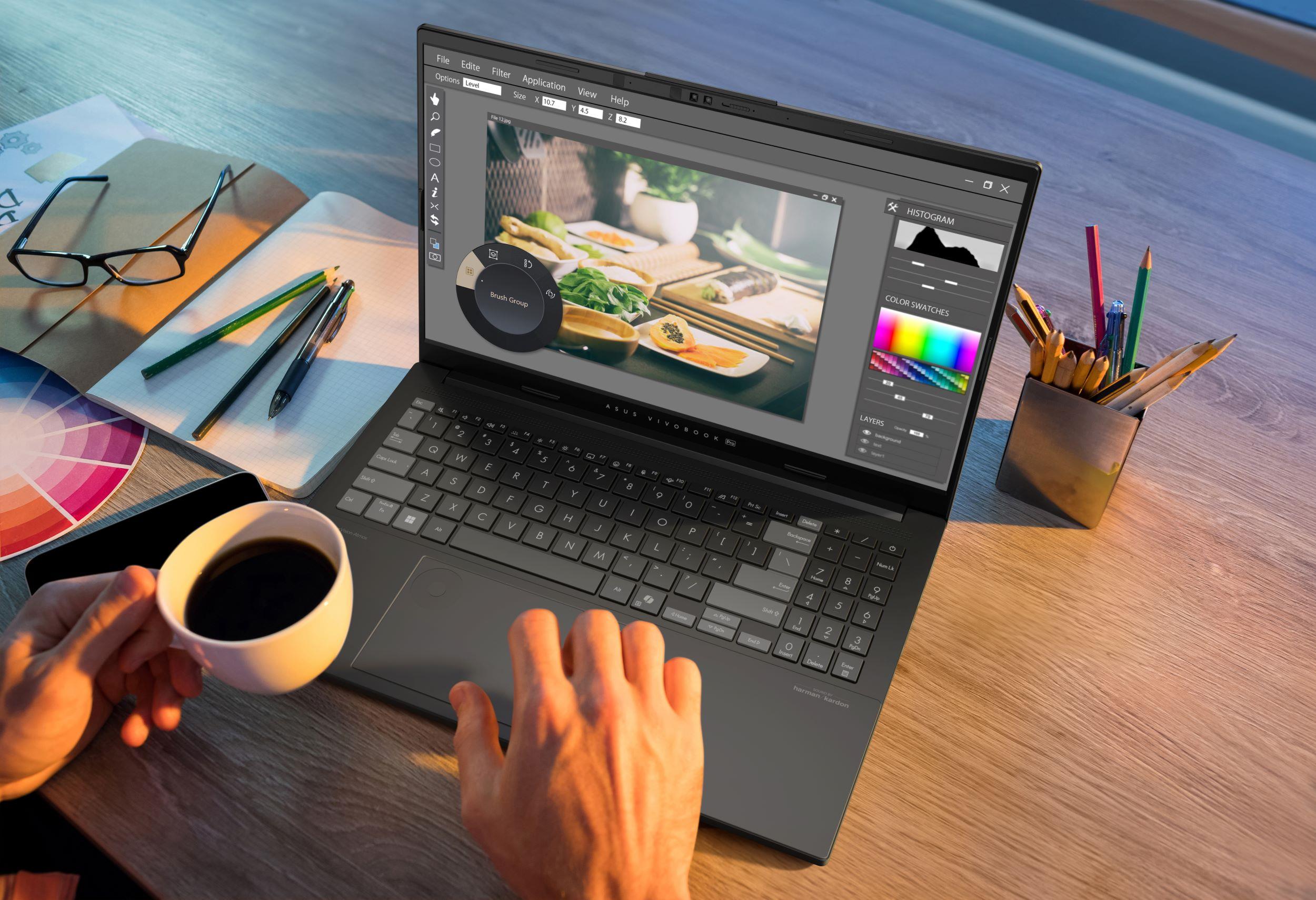 A point-of-view image of an ASUS Vivobook open to image editing software